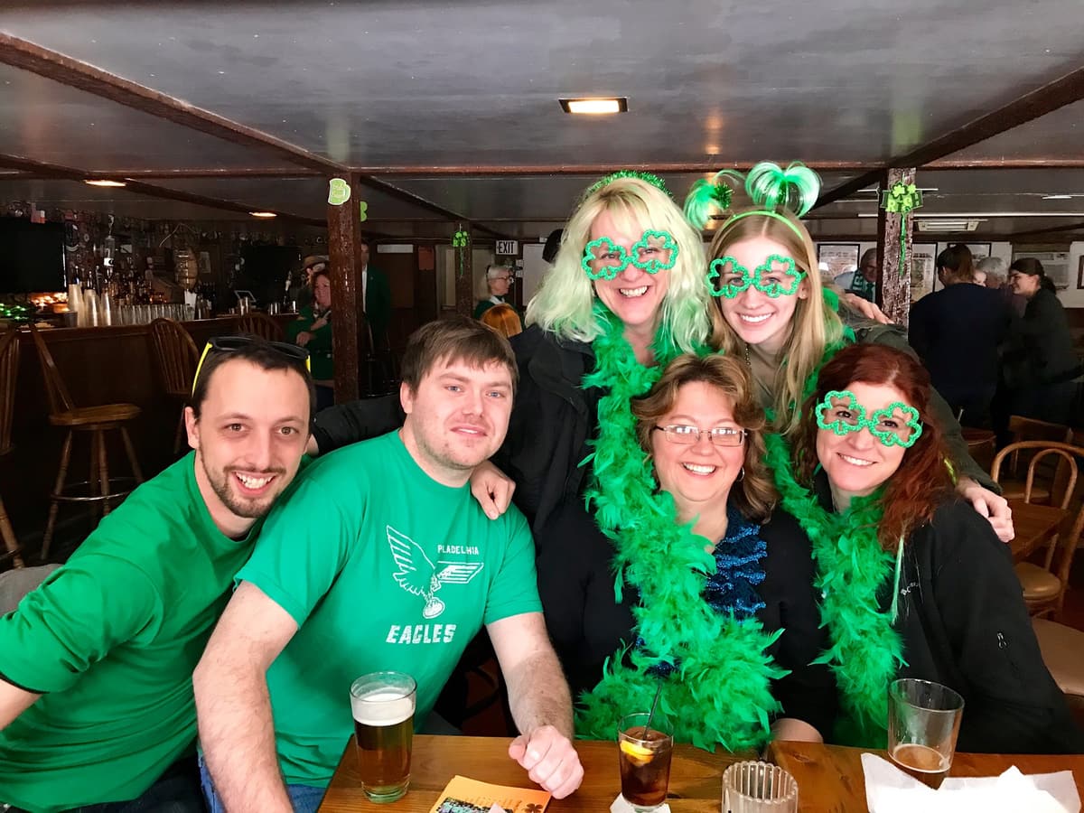Friends in green hats and boas celebrating St. Patrick's Day 2019 at Gavin's Pub