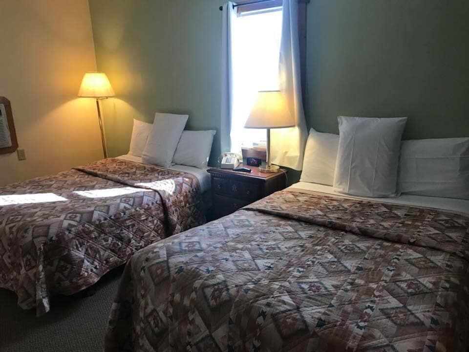 Standard Country View room with two double beds, lamps and nightstand