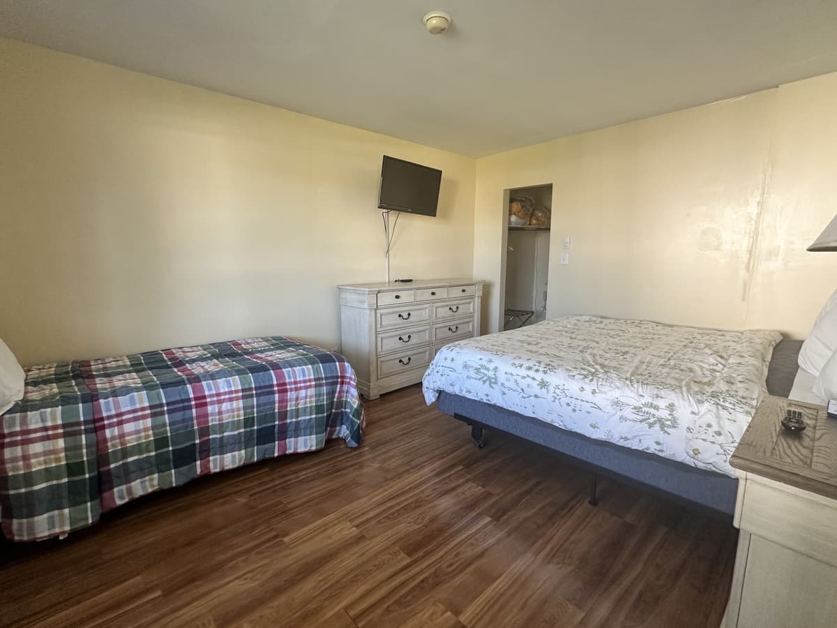 Suite bedroom with a king bed and a trundle bed for kids