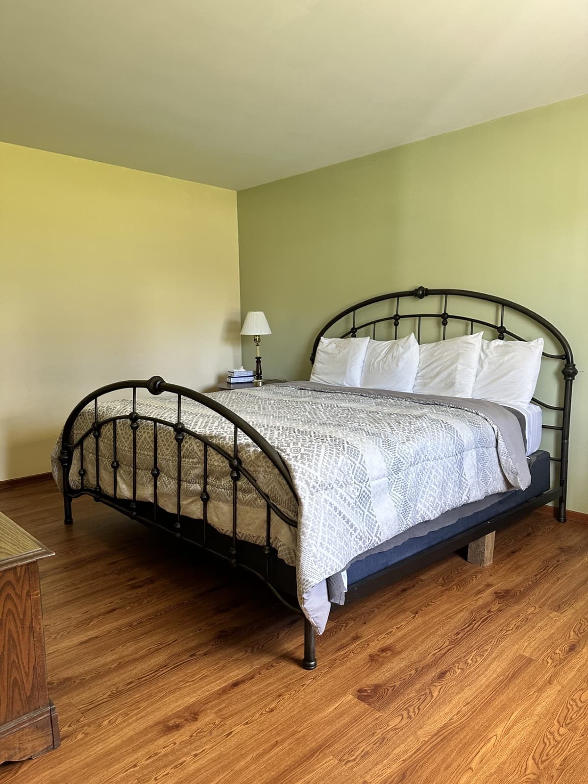 King bed with an iron headboard in a two-bedroom suite at Gavin's