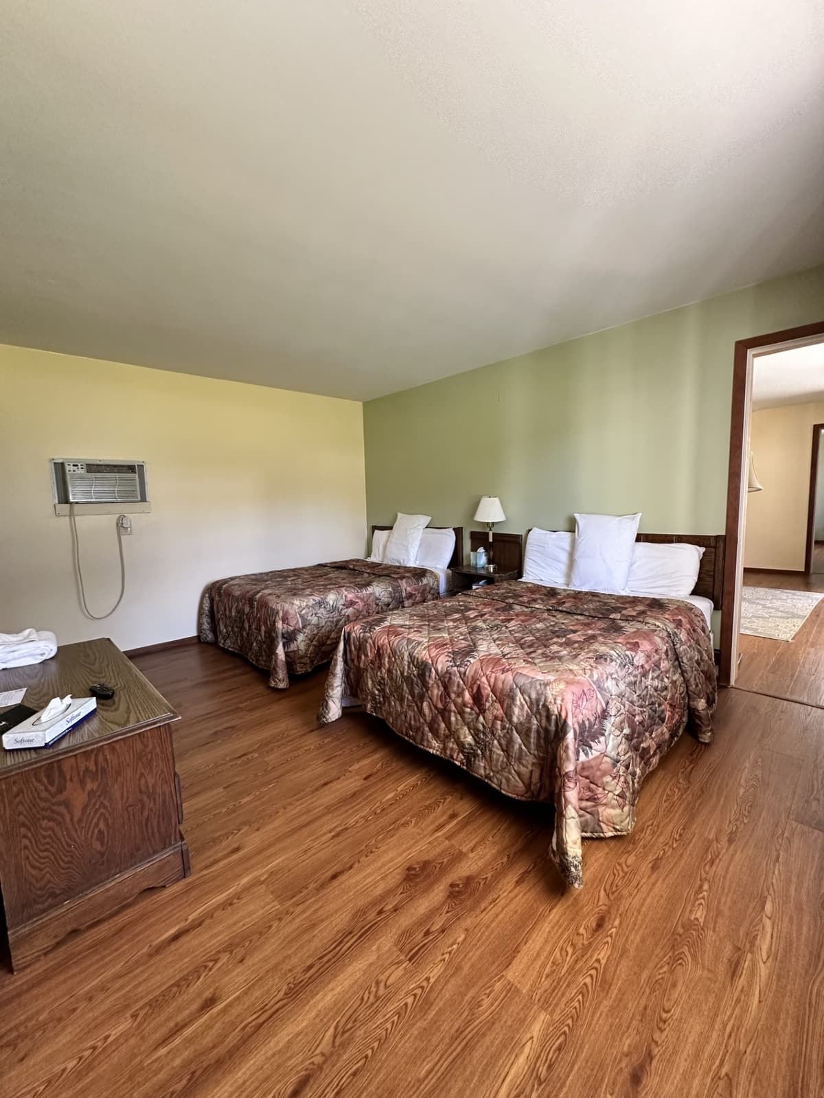 Two-bedroom suite bedroom with two double beds and wood floors
