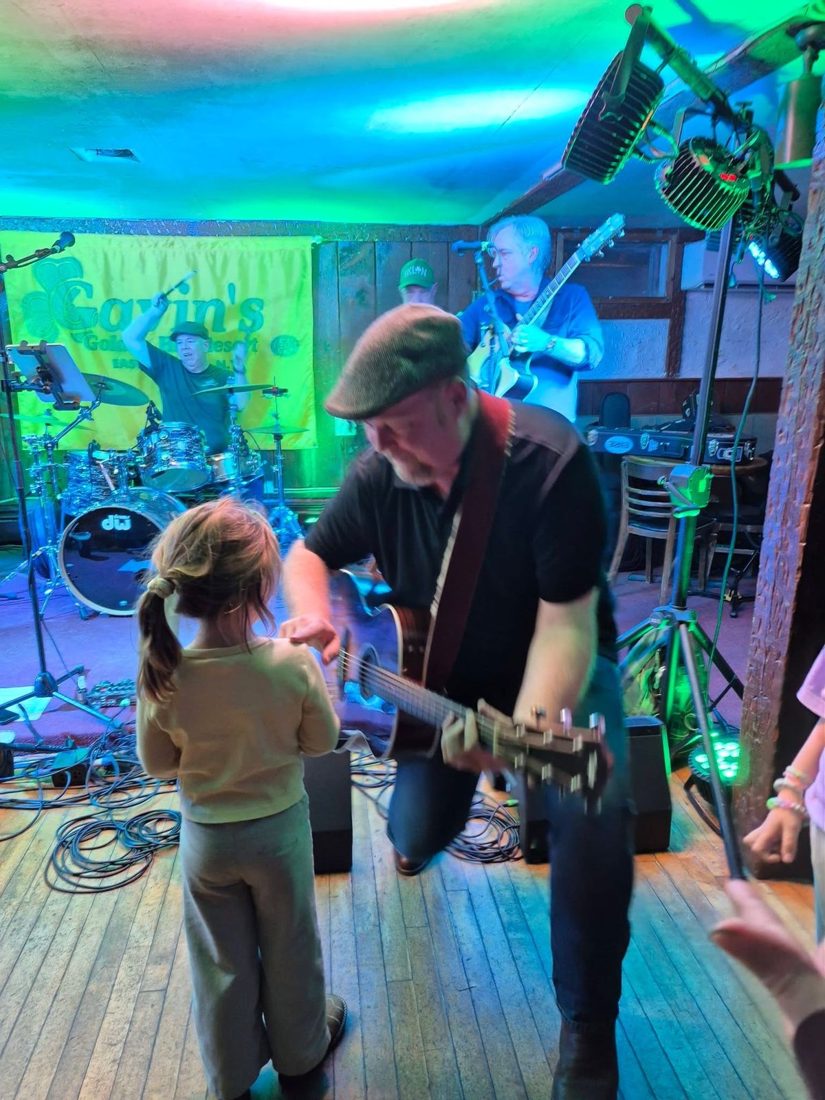 Guitarist playing for a young fan at Gavin's Pub
